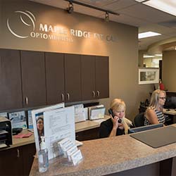 front reception desk at mpale ridge eye care, two women sitting and one on the phone