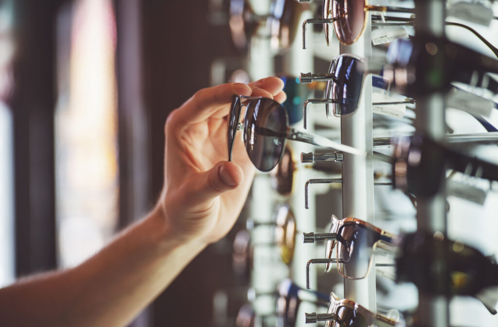 A man picks out a pair of sunglasses at his optometrist's office