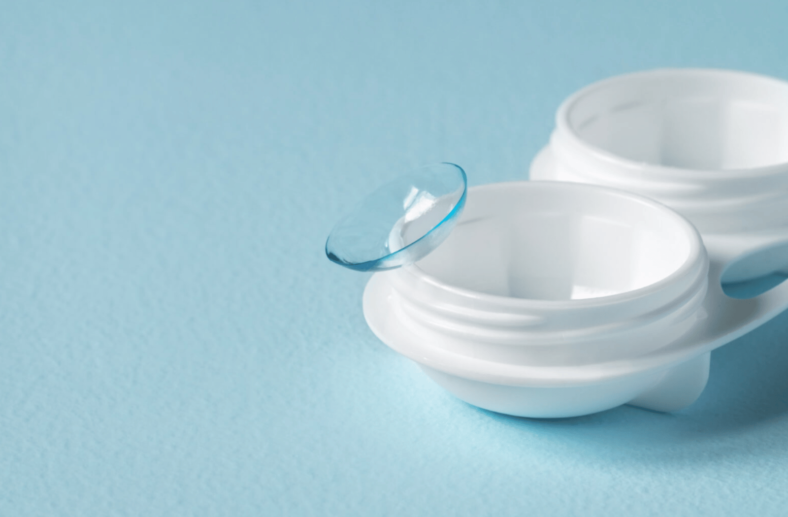A close-up of a contact lens on a plastic lens container