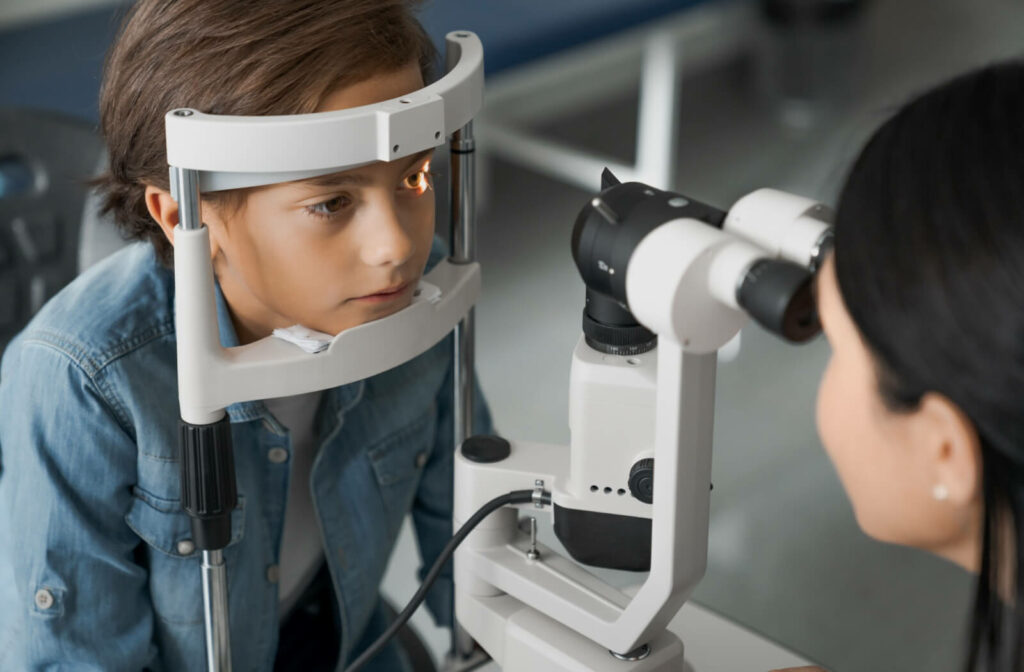 A child getting an eye exam from an optometrist.