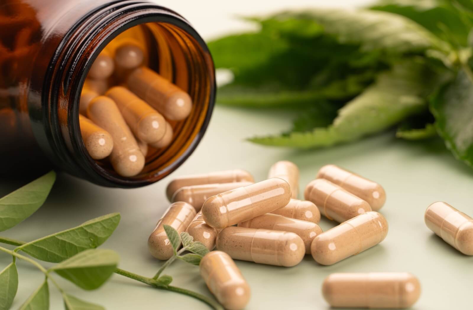 Vitamin capsules pouring out of the container.