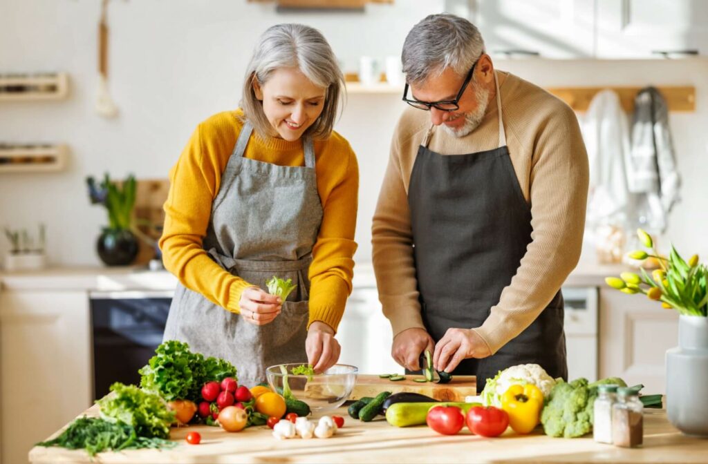 A mature couple prepares a nutritious, eye-friendly meal in their kitchen.